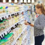 women looking at seasoning in aisle