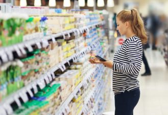 women looking at seasoning in aisle