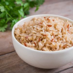 Bowl of Brown Rice on Wooden Table