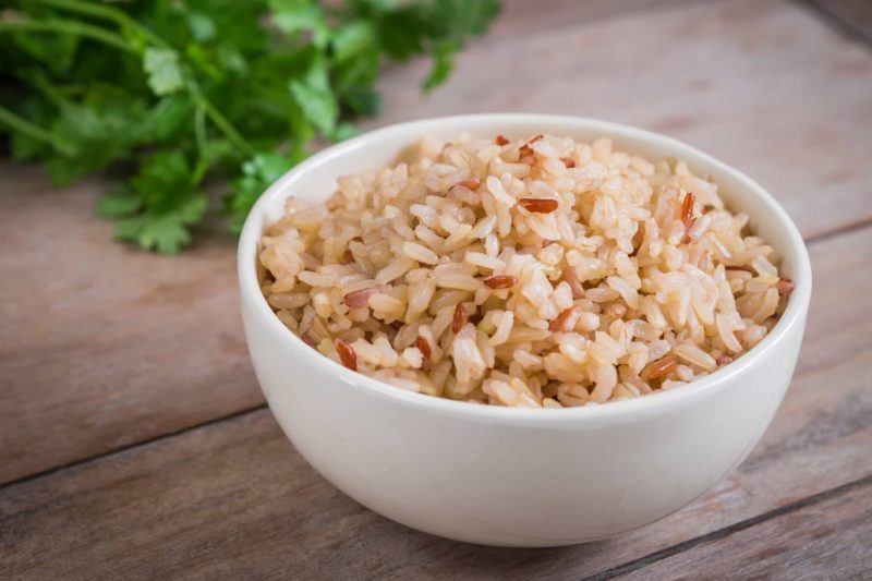 Bowl of Brown Rice on Wooden Table