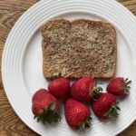 Peanut butter toast with hemp seeds, cinnamon and strawberries