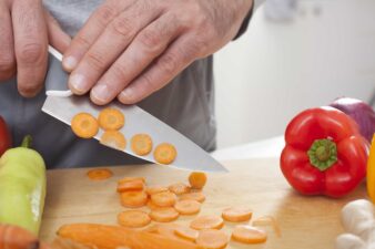 Man Cutting Carrot Into Rondelle Knife Cut Shape